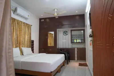 a hotel room with a bed and a kitchen at Mountain river farm resort in Agali