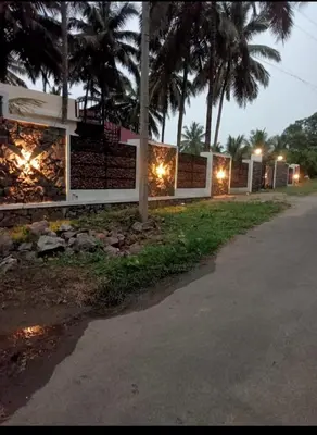 a building with lights on the side of a road at Mountain river farm resort in Agali