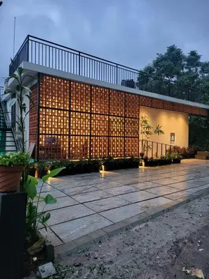 a building with lights on the side of it at Mountain Serenity Meppadi, Wayanad in Kalpetta