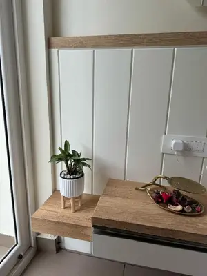 a table with a plant on it next to a window at Mountain Serenity Meppadi, Wayanad in Kalpetta