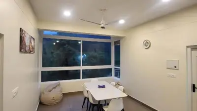 a dining room with a table and a window at Mountain Serenity Meppadi, Wayanad in Kalpetta