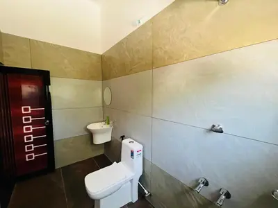 a bathroom with a toilet and a sink at Aagneyam mansion in Kozhikode