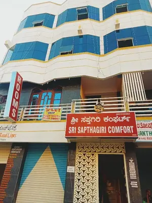 a building with a sign in front of it at Sri Sapthagiri comfort in Mysore