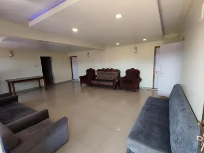 a living room with couches and chairs in a room at R R K Residency in Ooty