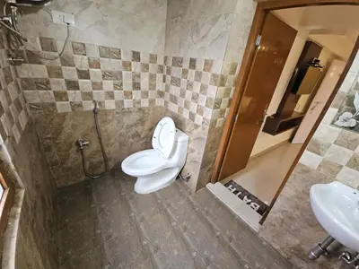 a bathroom with a toilet and a sink at R R K Residency in Ooty