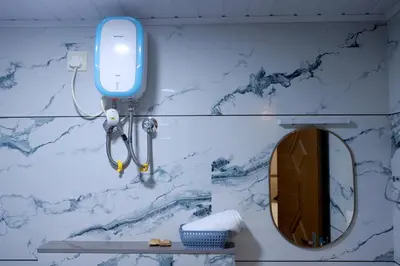 a bathroom with a mirror and a blue phone on a wall at Luxairy in Chewarra