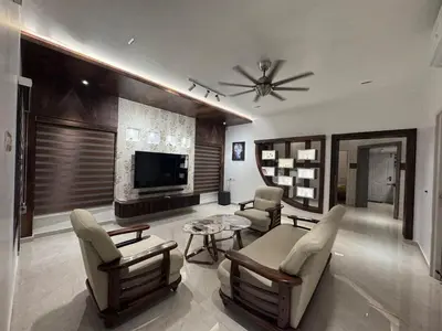 a living room with a couch and chairs and a television at Vels Villa A home away from home at Pollachi in Pollāchi