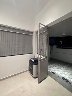 an empty room with a cage in a room at Vels Villa A home away from home at Pollachi in Pollāchi