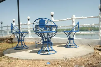 three blue chairs sitting on top of a table at Voitto Vista in Cochin