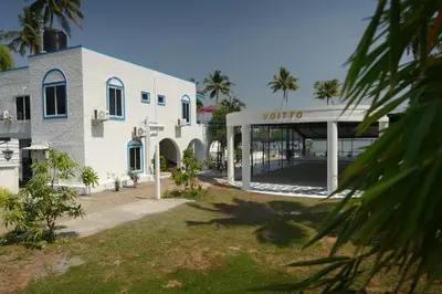 a white building with a sign that reads vlore at Voitto Vista in Cochin