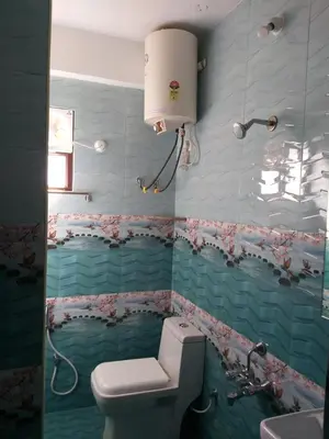 a bathroom with a toilet and a sink at Sri Sai Residency Ooty in Ooty