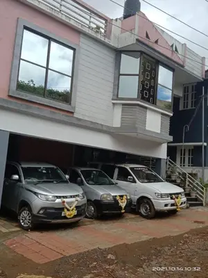 three cars parked in front of a building at Sri Sai Residency Ooty in Ooty