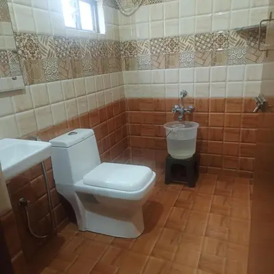 a bathroom with a toilet and a sink at Sri Sai Residency Ooty in Ooty