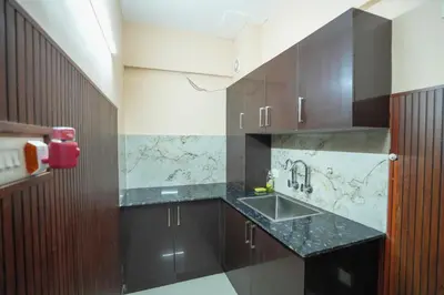 a kitchen with a sink and a counter top at Stella Marries Airpot Lounge in Nedumbassery