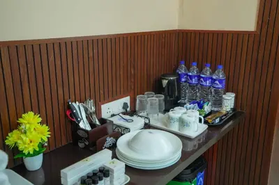 a counter with plates and bottles of water on it at Stella Marries Airpot Lounge in Nedumbassery