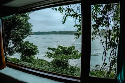 a view of the ocean from a window at Kadal boutique beach stay in Green Island