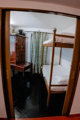 a bedroom with a bunk bed and a table at Kadal boutique beach stay in Green Island