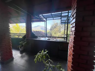 a balcony with a sink and a view of a mountain at CASTELLO Holiday Villa in Kalpetta