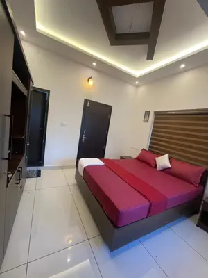 a bedroom with a large red bed in a room at CASTELLO Holiday Villa in Kalpetta