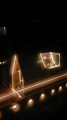 a house with lights on the side of it at night at Casa de Selas - A Chalet Stay in Coonoor