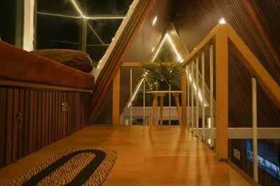 a room with a staircase with a table and a plant at Casa de Selas - A Chalet Stay in Coonoor
