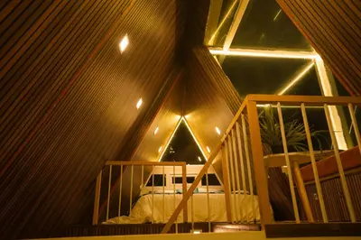 a room with a bed and a large window at Casa de Selas - A Chalet Stay in Coonoor