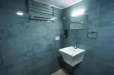 a bathroom with a sink and a mirror at Casa de Selas - A Chalet Stay in Coonoor
