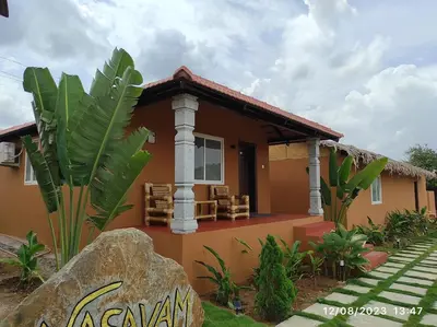 a house with a large rock in front of it at V Nature Resorts in Kanakapura