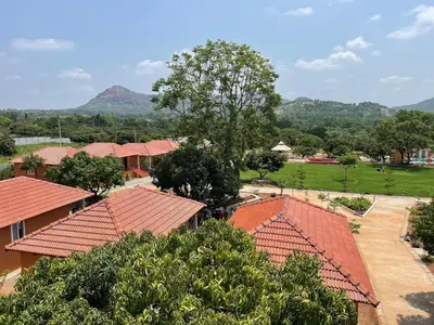 an overhead view of a group of houses with red roofs at V Nature Resorts in Kanakapura