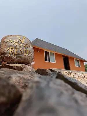 a house with a rock in front of it at V Nature Resorts in Kanakapura