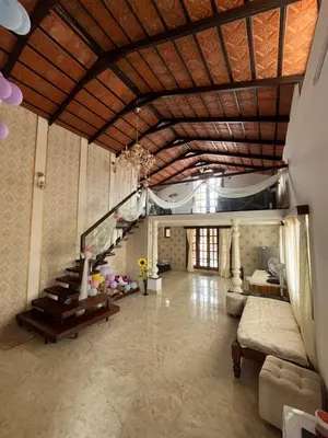 a living room with a slide in the middle of it at Aaloka stay in Mysore