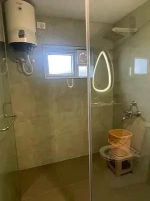 a shower with a glass door in a bathroom at Casa De KCN in Kotagiri