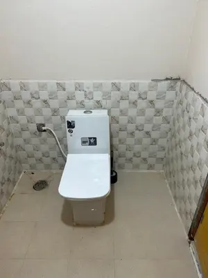 a bathroom with a white toilet in a room at Sogni D oro in Mysore