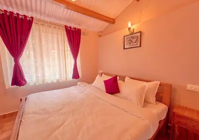 a bedroom with a white bed with red curtains at Silver Dale Tea Estate Bungalow Ooty by VOYE HOMES in Ooty