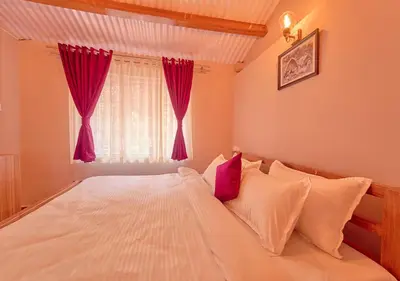a bedroom with a large white bed with red curtains at Silver Dale Tea Estate Bungalow Ooty by VOYE HOMES in Ooty