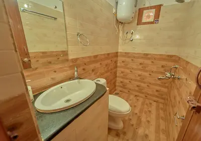 a bathroom with a sink and a toilet at Silver Dale Tea Estate Bungalow Ooty by VOYE HOMES in Ooty