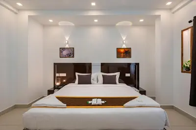 a bedroom with a large bed in a room at Cochin Airport Hotel in Ernakulam
