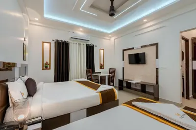 a hotel room with a bed and a television at Cochin Airport Hotel in Ernakulam