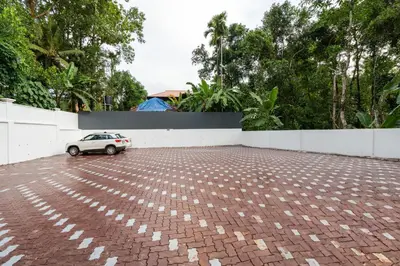 a small car parked in a brick parking lot at Cochin Airport Hotel in Ernakulam