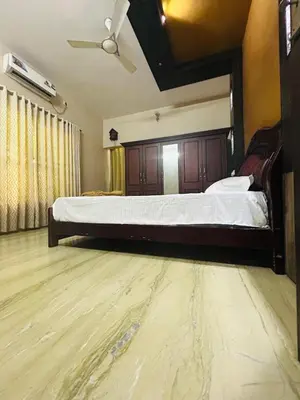 a bedroom with a large bed in a room at Stay Easy - Potta, Athirapally Road in Kizhake Chālakudi