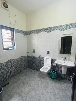 a bathroom with a toilet and a sink at Stay Easy - Potta, Athirapally Road in Kizhake Chālakudi