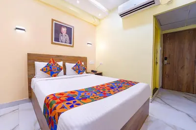 a bedroom with a large bed in a room at FabHotel INK - Nr Coimbatore North Railway Station in Coimbatore