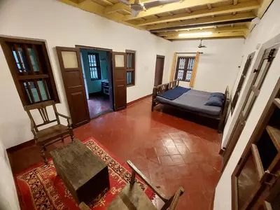 a room with a bed and a table in it at VIHA The Heaven in Meppādi
