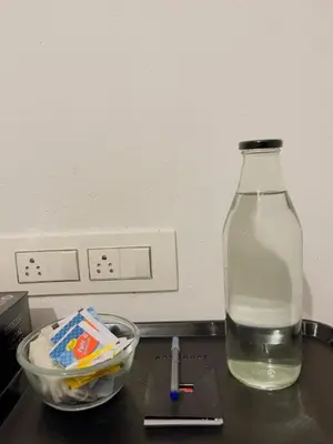 a bottle of water and a bowl on a counter at RiverSoul Villa in North Paravur