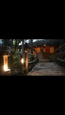 a wooden walkway with lights on top of it at HeavensAway in Marayoor