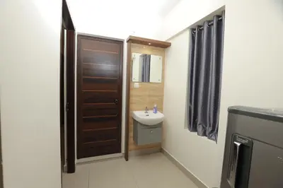 a small bathroom with a sink and a toilet at Classic Cochin Airport Hotel in Nedumbassery
