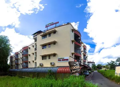 a tall building with a sign in front of it at Classic Cochin Airport Hotel in Nedumbassery