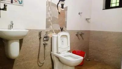 a bathroom with a toilet and a sink at Classic Cochin Airport Hotel in Nedumbassery