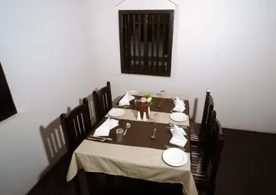 a table with a doll sitting on top of it at Krishnapuram Heritage Resort in Karimpuzha