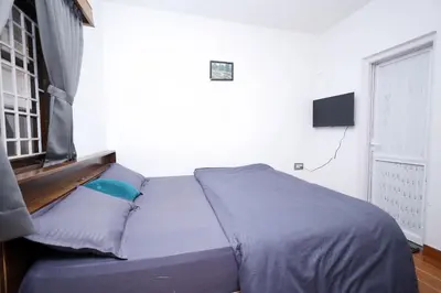 a bed sitting in a bedroom with a window at Travel & Stay in Ooty